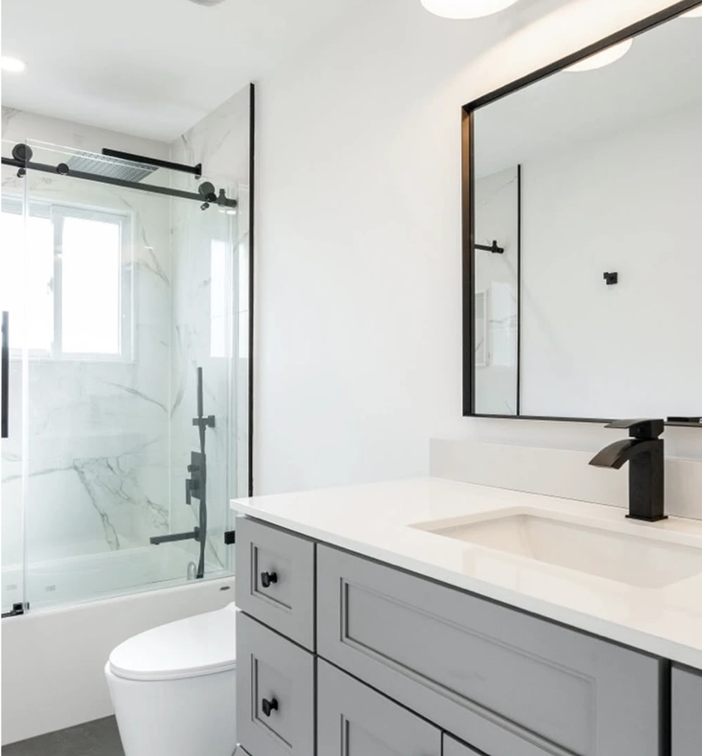 Modern bathroom with shower-over-tub and black accent fixtures